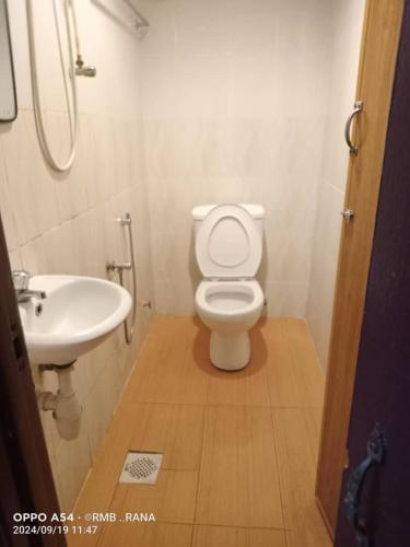 a bathroom with a white toilet and a sink at perfect class hotel in Kuala Lumpur
