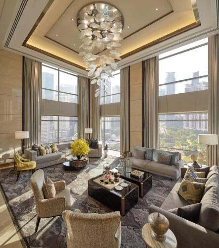 a large living room with couches and a chandelier at Mandarin Oriental, Kuala Lumpur in Kuala Lumpur