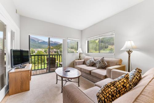 a living room with a couch and a tv at Greens at Copper 219 in Copper Mountain