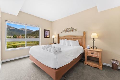 a bedroom with a large bed and a window at Greens at Copper 214 by Summit County Mountain Retreats in Copper Mountain