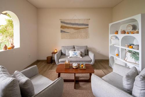 a living room with two couches and a table at Kayumas Seminyak Resort in Seminyak