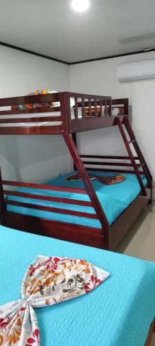 two bunk beds in a room with a table at Casa Osa Azul in Puerto Jiménez
