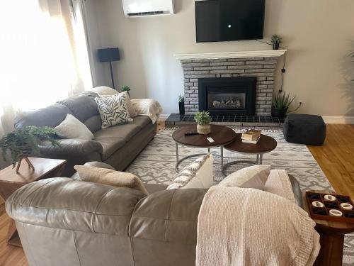 a living room with a couch and a fireplace at University Manor in Moncton