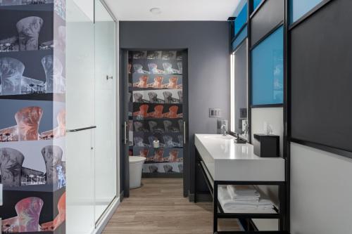 a bathroom with a sink and a mirror at Aloft Orlando Lake Nona in Orlando
