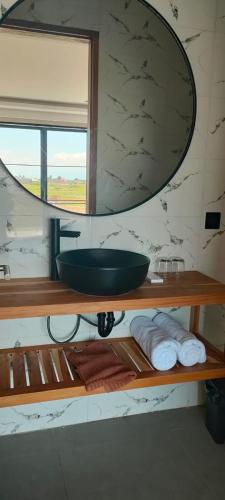 a bathroom with a sink and a mirror at Paddy's House Seseh in Canggu