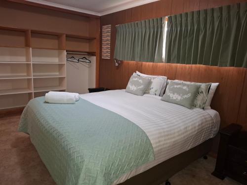 ein Schlafzimmer mit einem großen Bett mit weißer Bettwäsche in der Unterkunft Pakenham Central in Echuca