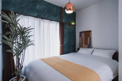 a bedroom with a bed and a large window at House YOYOGI Park, Shibuya Area, 4 Minutes to Yoyogi Park, 4-Bedroom, Sleeps 8 in Tokyo