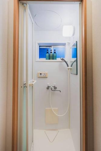 a shower in a bathroom with a glass door at House YOYOGI Park, Shibuya Area, 4 Minutes to Yoyogi Park, 4-Bedroom, Sleeps 8 in Tokyo