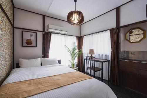 a bedroom with a bed and a desk in it at House YOYOGI Park, Shibuya Area, 4 Minutes to Yoyogi Park, 4-Bedroom, Sleeps 8 in Tokyo