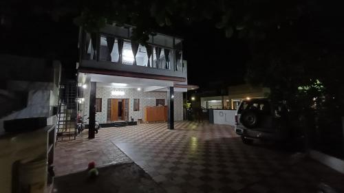 a parking lot with a building with a balcony at SHI's Kurunji 5BHK Villa in Pollachi in Pollāchi