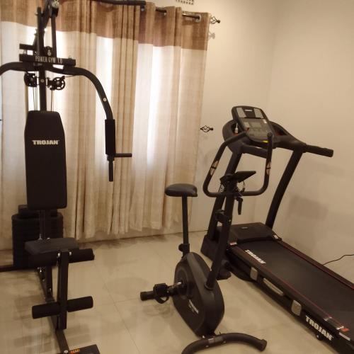 a gym with a treadmill and a exercise bike at Elegant BnB in Bulawayo