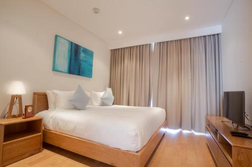 Postel nebo postele na pokoji v ubytování The Ocean Resort Danang