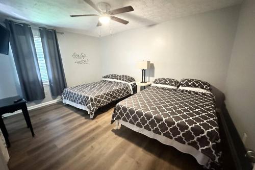 a bedroom with two beds and a ceiling fan at Stone Mountain's Hidden Secret in Stone Mountain