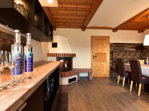a kitchen with a bar with bottles of wine at Apartment in Schwalbenhof farm in Haselbach
