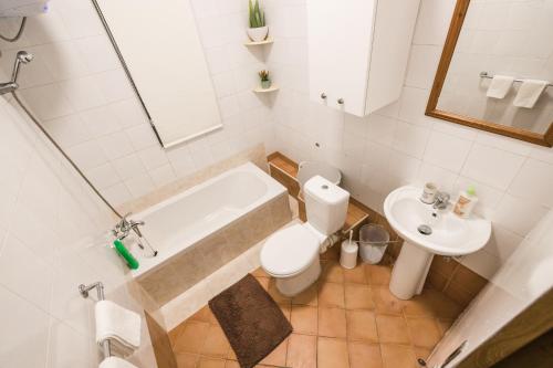 a bathroom with a tub and a toilet and a sink at Sliema 3 bedrooms apartment in Sliema