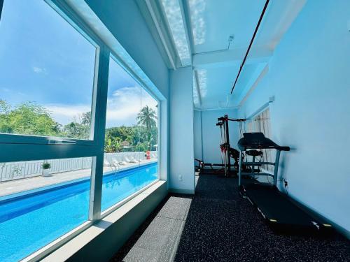 a room with a swimming pool and windows at The Up Hotel Phu Quoc Island - The Poolside Escape in Phu Quoc