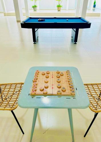 a table with a tray of donuts on it at The Up Hotel Phu Quoc Island - The Poolside Escape in Phu Quoc