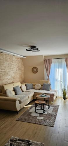 a living room with a couch and a table at Green Hill Isidorovic Divcibare in Divčibare
