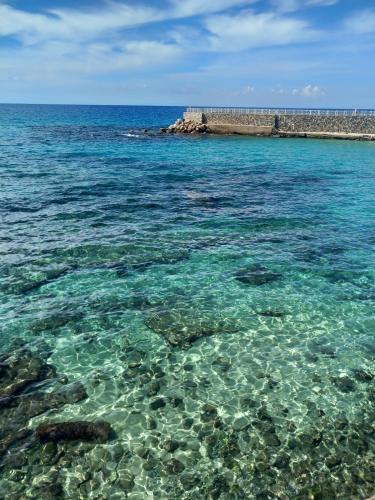 a view of the ocean with rocks and water at Palazzo Sardanelli in Pizzo