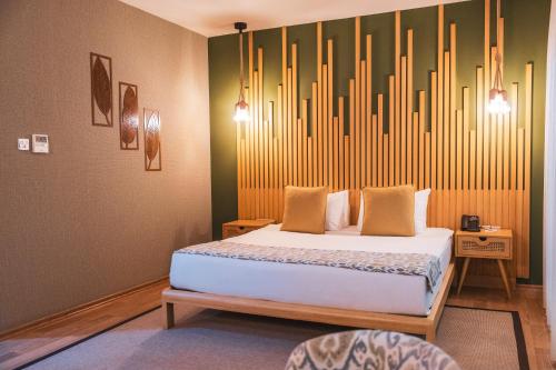 a bedroom with a bed with a large headboard at La Terrazza Hotel in Mağusa