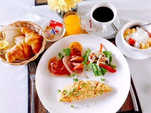 a plate of breakfast food and a cup of coffee at The Center Point in Siem Reap