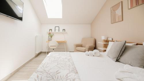 a white bedroom with a bed and a desk at Botanic Apartments - Suite in Naples