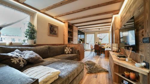 a living room with a couch and a large window at Alpine Suite - Cervinia in Breuil-Cervinia