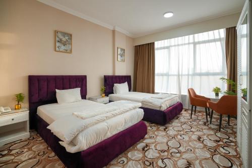 Voodi või voodid majutusasutuse Sur Inn Hotel Apartments صور ان للشقق الفندقية toas
