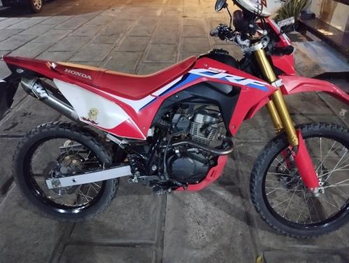 a red and white motorcycle parked on a street at Hotel Tentrem Syariah in Probolinggo