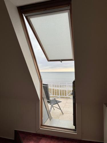 a window in a room with a view of the ocean at Strandhotel Dünenhaus in Juliusruh
