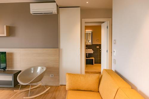 a living room with a couch and a television at Lido Vista Apartments in Lazise