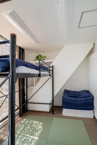 a room with bunk beds and a balcony at 広島ゲストハウス Nice Day in Hiroshima