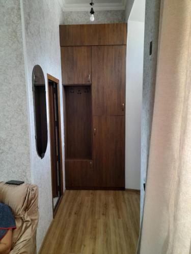 a room with a wooden door and a wooden floor at Armani Apartment in Akhaltsikhe