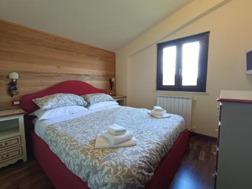 a bedroom with a bed with towels on it at La Maison in Pescocostanzo