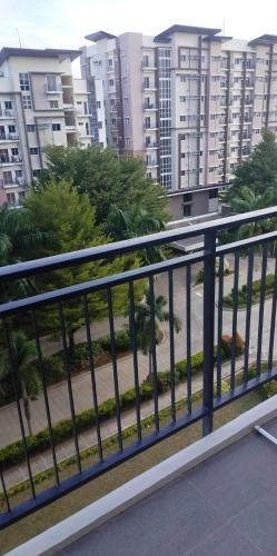 a railing on a balcony with buildings in the background at Matina Enclaves 2BR with Wifi Near SM Mall in Davao City