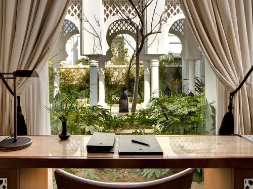 an office with a table with a laptop on it at Banyan Tree Tamouda Bay in Fnidek