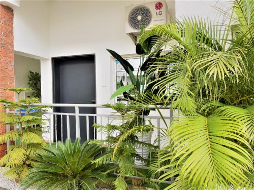 a bunch of plants in front of a house at Imperio Apartments in Abuja