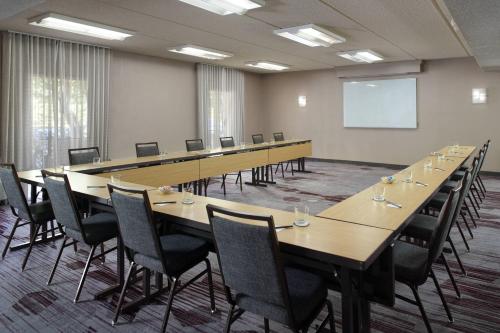 a large conference room with a long table and chairs at Courtyard Charlotte Arrowood in Charlotte