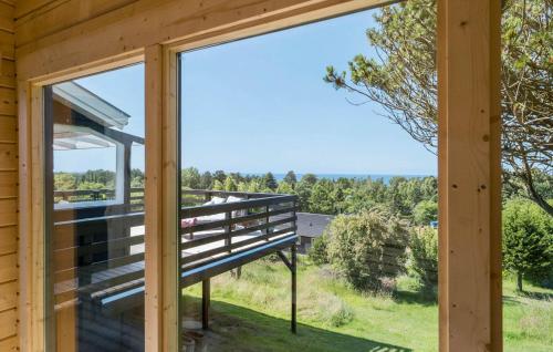 a view from the porch of a cabin with a large window at 3 Bedroom Cozy Home In Fårevejle in Fårevejle
