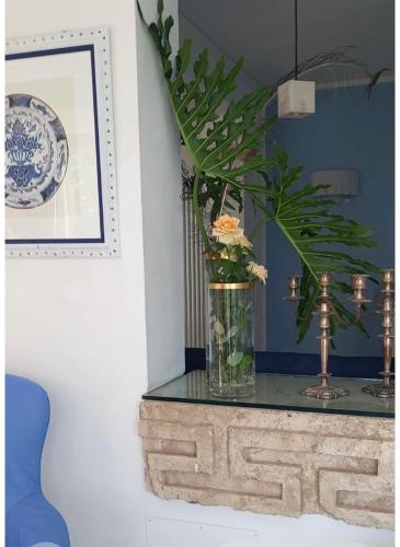 a vase with flowers on a table in a room at Casa Azzurra in Messina