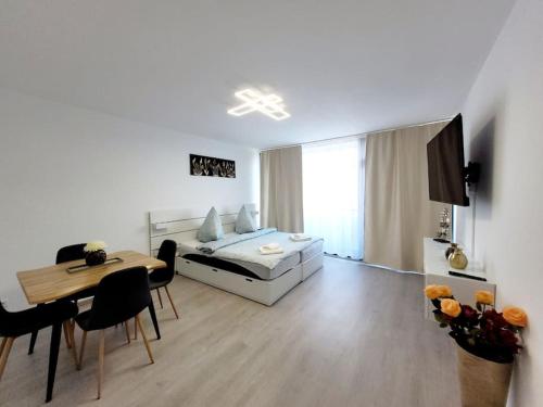 a living room with a bed and a dining table at 2 Zimmer Wohnung in Zentrale Lage in Mülheim an der Ruhr