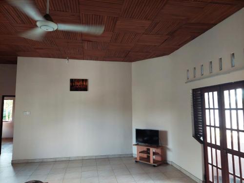 a room with white walls and a wooden ceiling at T Home in Moratuwa