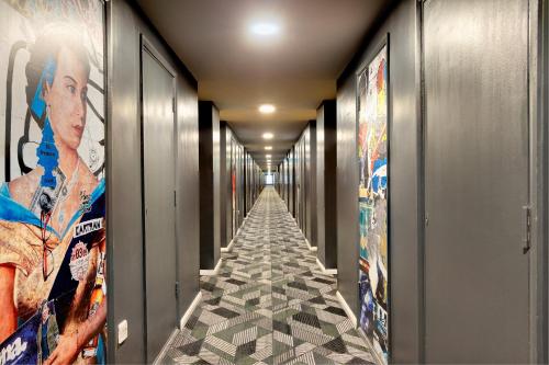 a corridor of a hallway with posters on the walls at Royal National Hotel in London