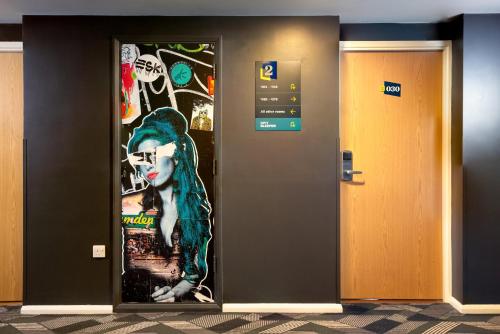 a door with a painting of a cat on it at Royal National Hotel in London