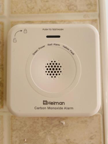 a white soap dispenser on a bathroom wall at Sunrise Home in Cosenza