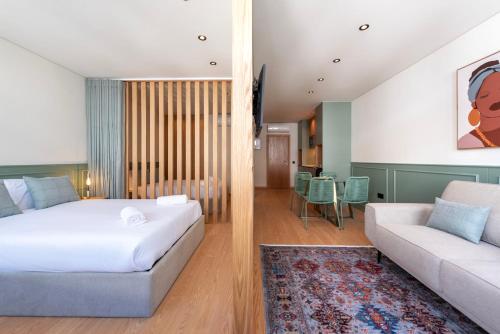a bedroom with a bed and a living room with a couch at Doispontozero Alegria Green in Porto