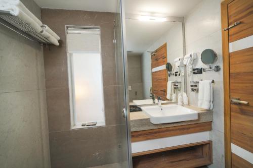 a bathroom with a sink and a mirror at Classic Regency in Alleppey