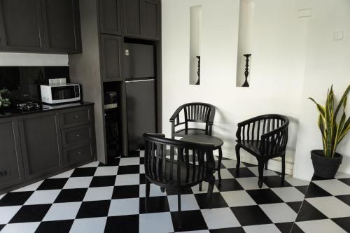 a kitchen with a black and white checkered floor at Saige House - Room in Shared Villa in Canggu