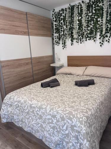 a bedroom with a bed with two pillows on it at Design seaview flat next to Yumbo in Playa del Ingles