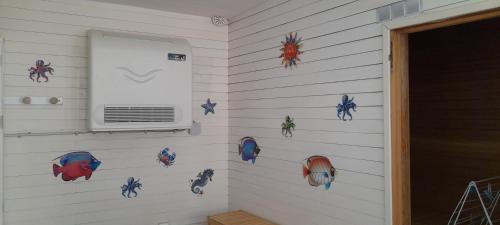 a room with a wall with fish decals on it at Gite Troubadour - Cap Gris Nez - piscine in Audinghen